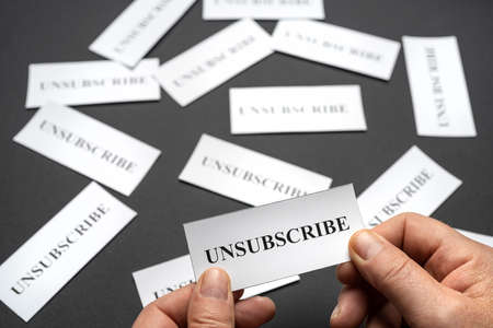 Some tickets with the word Unsubscribe arranged on the table, as a concept of the choice to cancel...