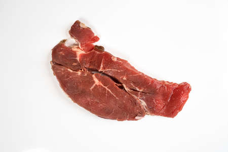 A roast beef steak isolated on a white surface