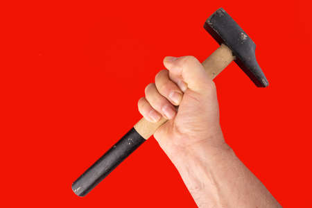 a man with a hammer in his hand with a red background