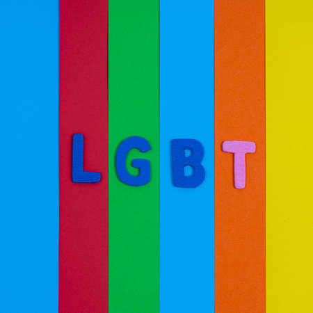 the word LGBT on a surface with some colored stripes to form a rainbowの写真素材