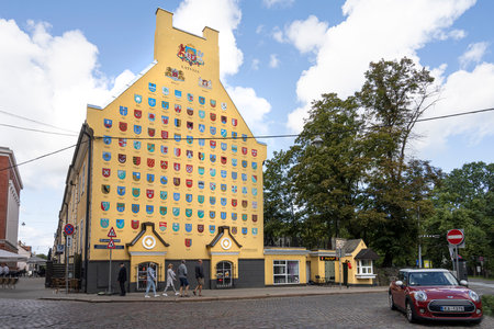 Riga, Latvia. 22 August 2021. the wall of a house with the representation of the coats of arms of...