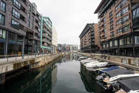 Oslo, Norway. September 2021. a canal with boats between the modern buildings of the city centerのeditorial素材