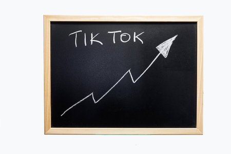 Udine, Italy. October 2021. Tik Tok's growth trend graph on a blackboardのeditorial素材
