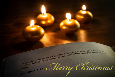 christmas bible verse with candles on the backgroundの写真素材