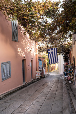 Athens, Greece. November 2021. a Greek flag hanging on a narrow alley in the Plaka neighborhood in the city centerのeditorial素材