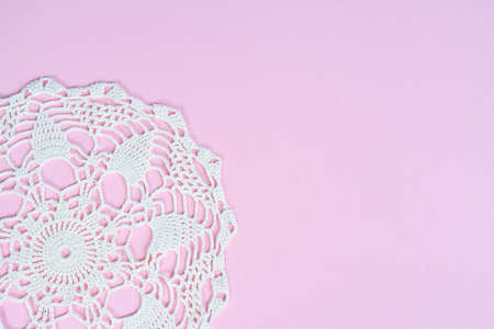 A white crochet embroidered doily on a blue surfaceの写真素材