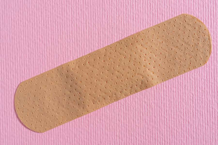 a plaster on a pink surfaceの写真素材