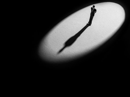 the shadow of a miniature model on a white surfaceの写真素材