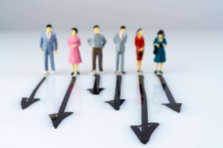 some miniature models in front of the direction to be taken on a white surfaceの写真素材