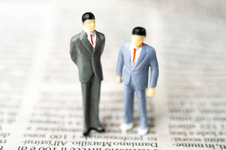 the figurine couple of two men on a page of the newspaper