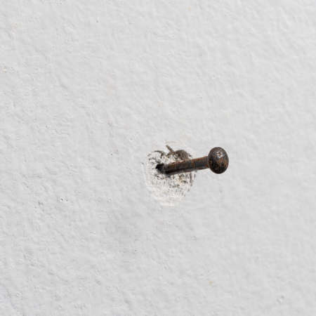detail of a nail driven into the wall