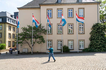 Luxembourg, May 2022. some Luxembourg flags in front of a building in the city centerのeditorial素材