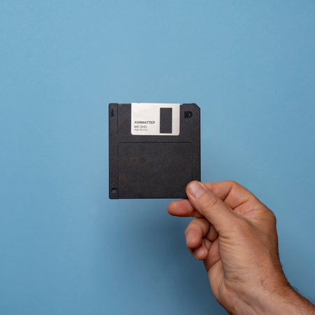 old floppy disk for data storage on handの写真素材