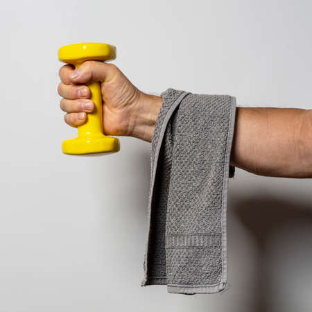 yellow gymnastic weights in handの写真素材