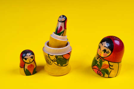 the matryoshka statuettes open on a yellow surfaceの写真素材