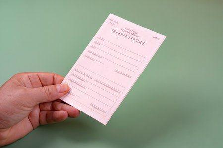 a man with a voting card for access to polling stations for voting in Italyのeditorial素材