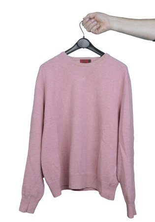 a pink shirt on a hanger in a male hand on a transparent background