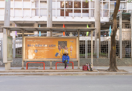 Hanoi, Vietnam, January 2023. A woman waiting the bus in the city centerのeditorial素材