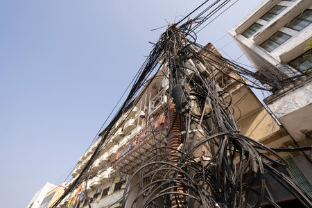 Hanoi, Vietnam, January 2023. a tangle of electrical cables in a city center street