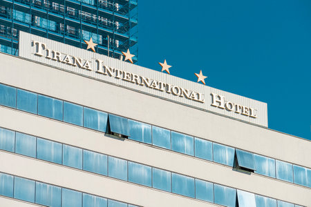 Tirana, Albania. March 2023. the sign Tirana International Hotel above a skyscraper in the city centerのeditorial素材