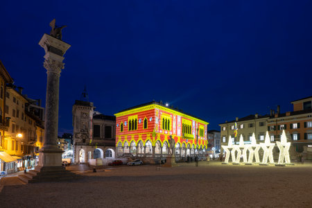 Udine, Italy, December 2023. the Christmas light decorations projected on the buildings of the historic center of the cityのeditorial素材