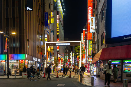Tokyo, Japan. January 9, 2024. night view of people walking among the lights of Musashino Street in...