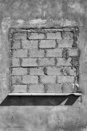 an old abandoned building with a bricked up window