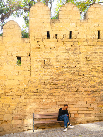 Baku, Azerbaijan. October 10, 2025. a man is dozing on the benchの素材