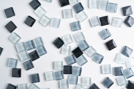 gray glass tiles scattered on a white background