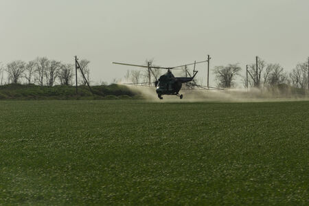 Irrigation with fertilizer from a helicopter  Application of aeronautical engineering in agriculture の写真素材