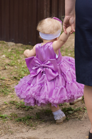 Beautiful little girl standing on the street in the model dress の写真素材