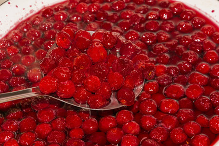 cooking cherry jam on a gas stove in the villageの写真素材