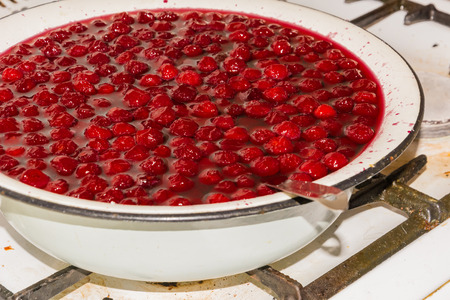 cooking cherry jam on a gas stove in the villageの写真素材