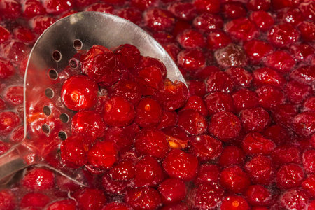 cooking cherry jam on a gas stove in the villageの写真素材