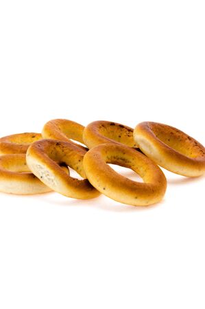 beautiful fresh bagels are combined by a heap on a white background