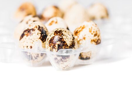 the tray with quail eggs was photographed on a white background