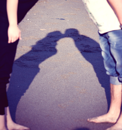 the shadow kissing couples was photographed on the street on walk