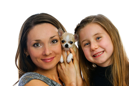 lovely beautiful girls with a doggie were photographed on a white backgroundの写真素材
