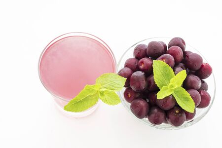 beautiful ripe sweet cherry and cherry juice were photographed in studioの写真素材