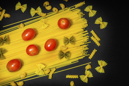 spaghetti with tomatoes on a black background were photographed in studioの写真素材