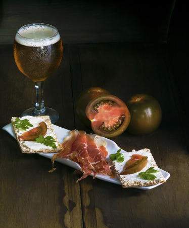 the appetizing plate of jamÃ³n with small loafs has been photographed in studioの写真素材