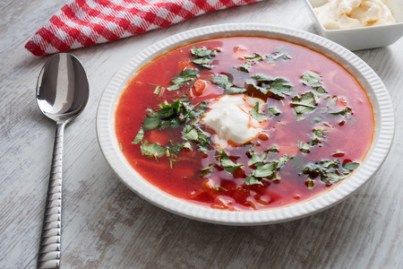 the fresh red beet soup poured in a plate has been photographed in studio