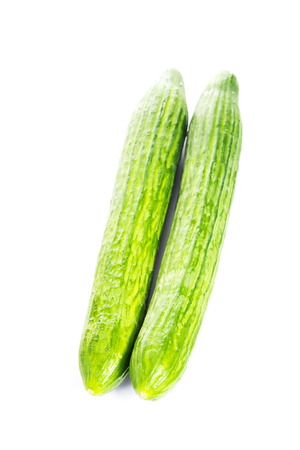 Fresh long cucumbers on white backgroundの写真素材