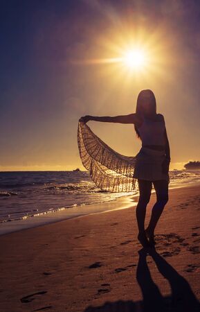 Beautiful girl in lock light with a spread skirtの写真素材