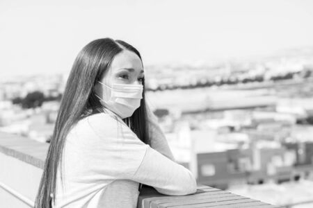 Beautiful girl in a rasterizing mask was photographed during quarantineの写真素材