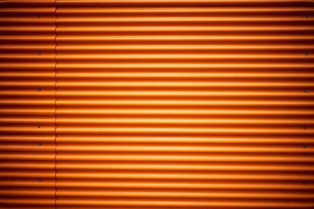 Orange corrugated metal sheet useful as a background - vertical imageの写真素材