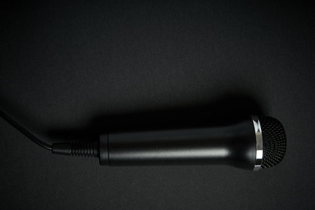 Black microphone on black backgroundの写真素材