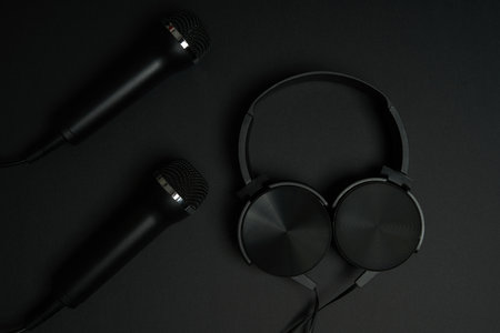 black microphone and headphones on a black backgroundの写真素材