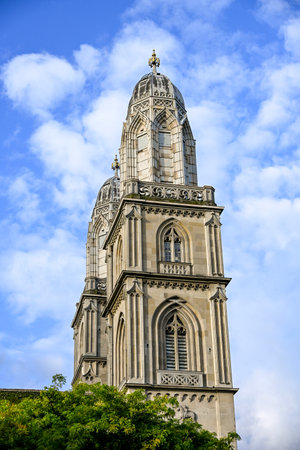 Close-up view of GrossmÃ¼nster twin towers in ZÃ¼rich, Switzerland, rising against a clear blue skyの写真素材