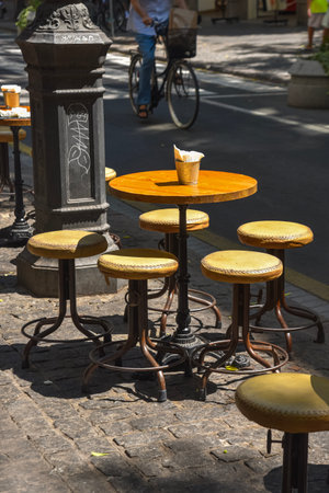 Outdoor cafÃ© stools and tables with empty drinks in Valencia, Spain, capturing Mediterranean street life and summer atmosphereの写真素材